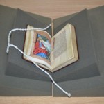 Book supports or cushions are used to protect bound volumes